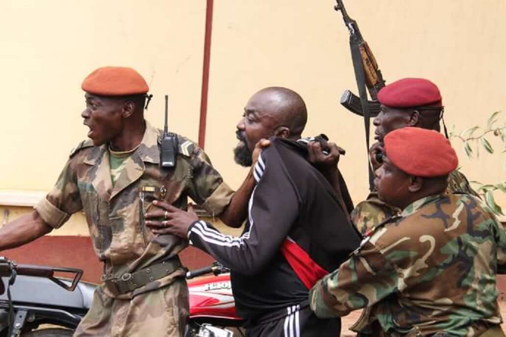 Members of the armed forces arrest Central African MP Alfred Yekatom aka "Rambo" (C), who represents the southern M'baiki district former militia leader, after he fired the gun at the parliament in Bangui on October 29, 2018. - A lawmaker fired into the air in the Central African Republic's parliament on October 29, 2018 after an altercation with a colleague as MPs prepared to vote for a new speaker. (Photo by Gael GRILHOT / AFP)